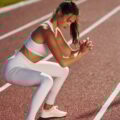 Focused athlete. Young woman in sportive clothes is exercising outdoors